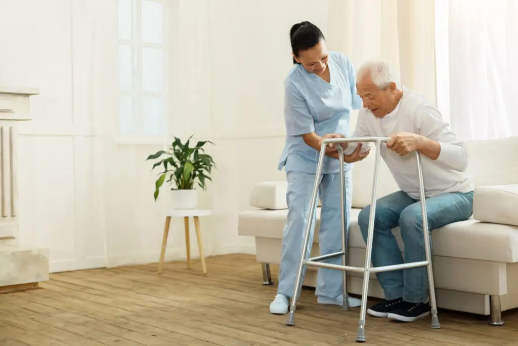Delighted positive caregiver helping her patient - The Williamsport Home